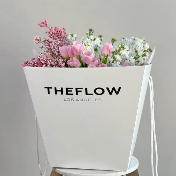 White TheFlow Los Angeles transport box with pink tulips and white stock