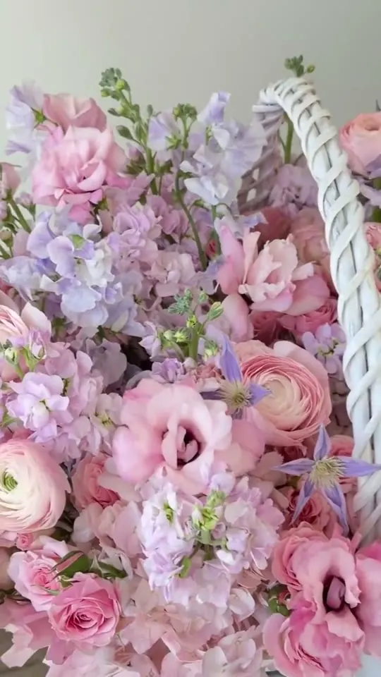 Roses, lisianthus and stock in a white flower basket made by TheFlow florists